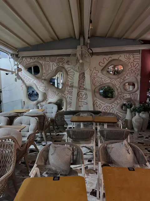 Kafe terasında hasır sandalyeler ve minderli koltuklar — Bornova, İzmir